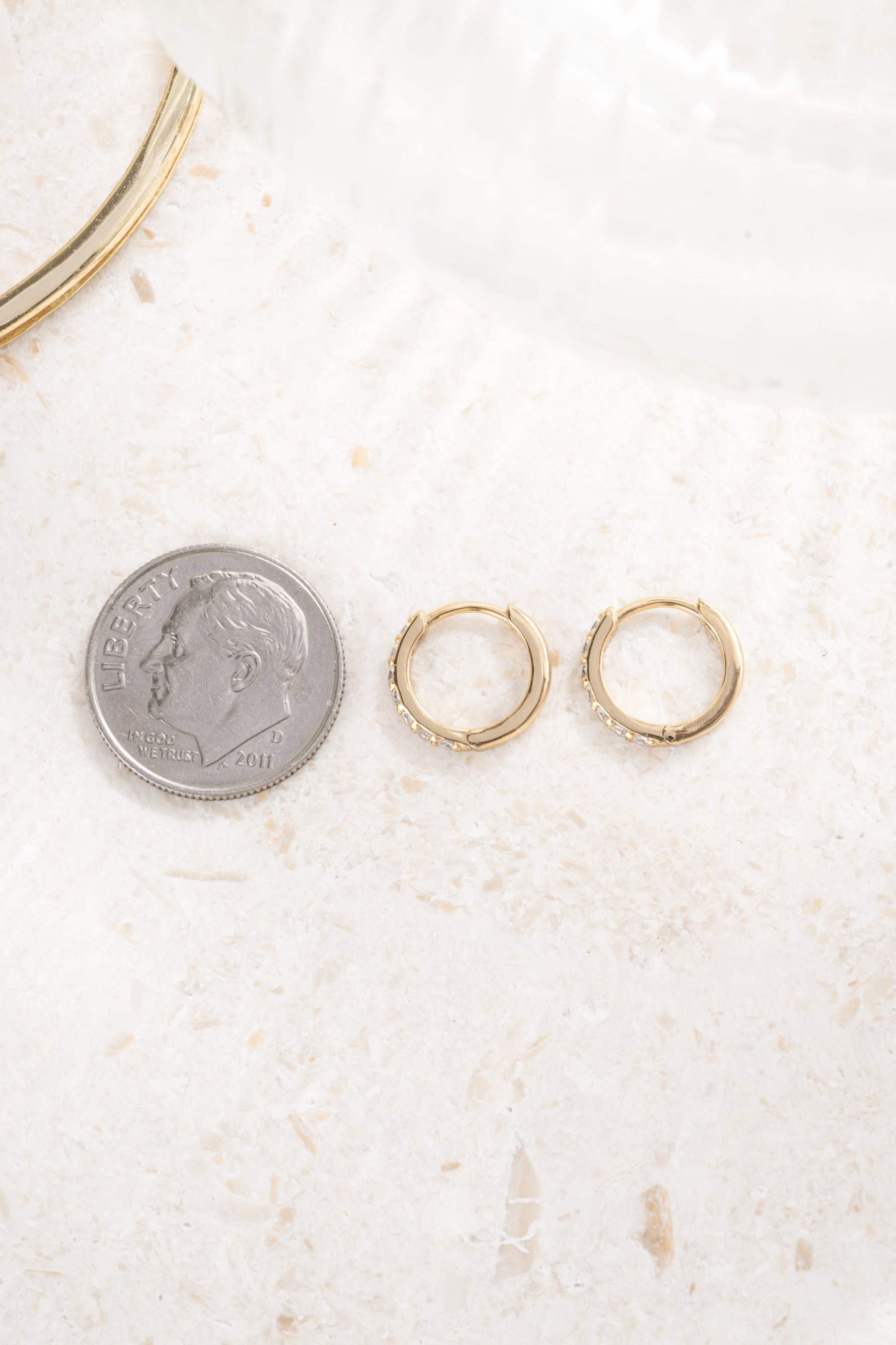 gold plated 8mm diamond studded huggie hoops compared to dime size