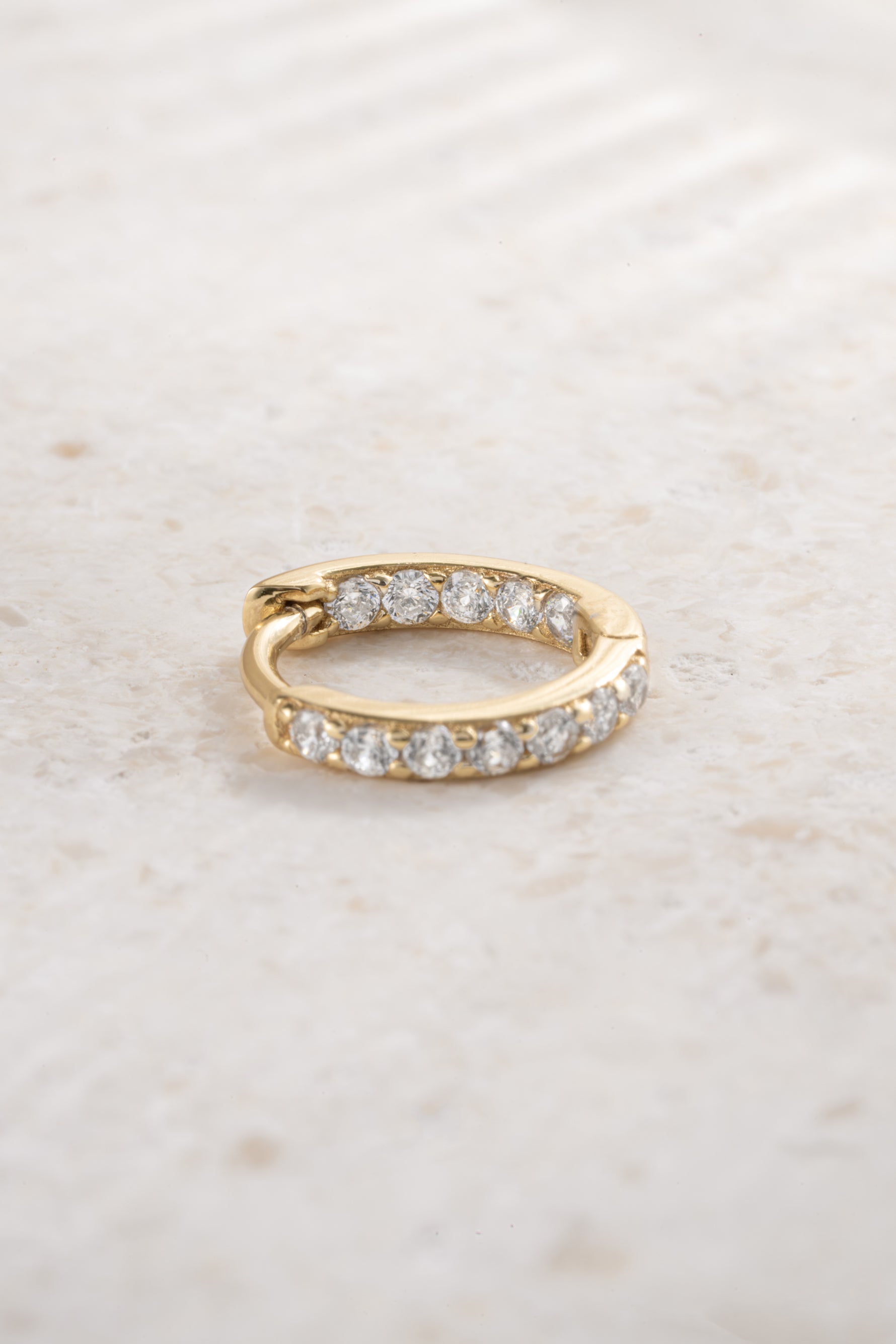 gold plated 9mm in and out diamond studded huggie hoop neutral background