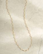 gold cream enamel beaded necklace neutral background