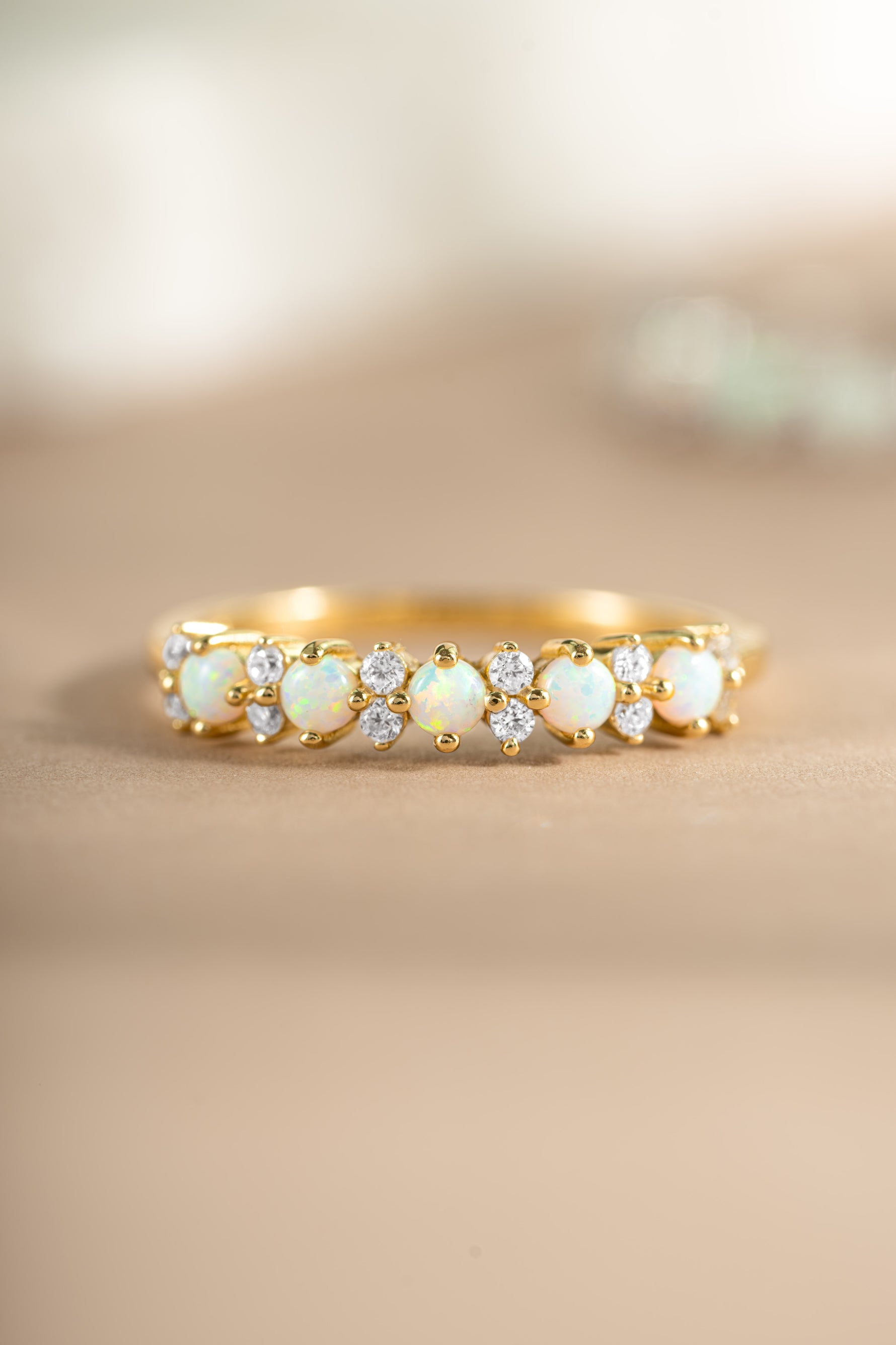gold opal and cubic zirconia stacking ring  on neutral background