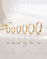 gold plated diamond studded huggies in sizes 7mm, 8mm, 10mm, 11mm, 13mm and 16mm, neutral background