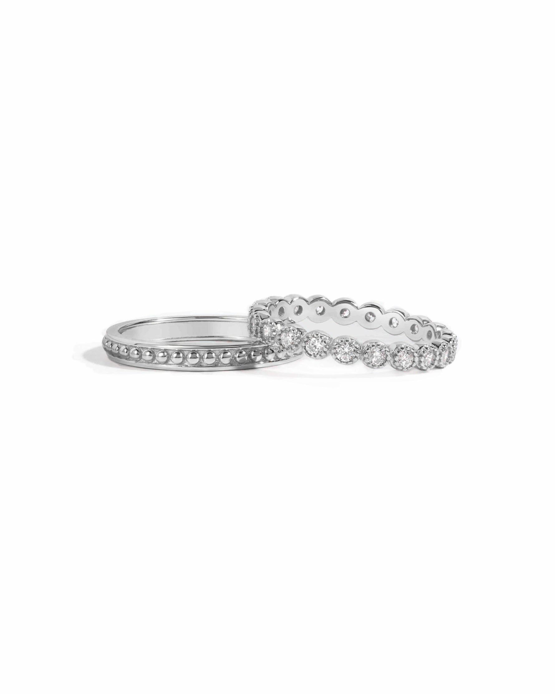 silver ring set, one with cz diamonds and one with a beaded ring design