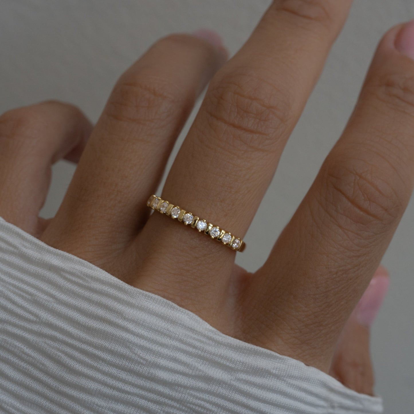 model wearing dainty gold cz fluted stacking ring