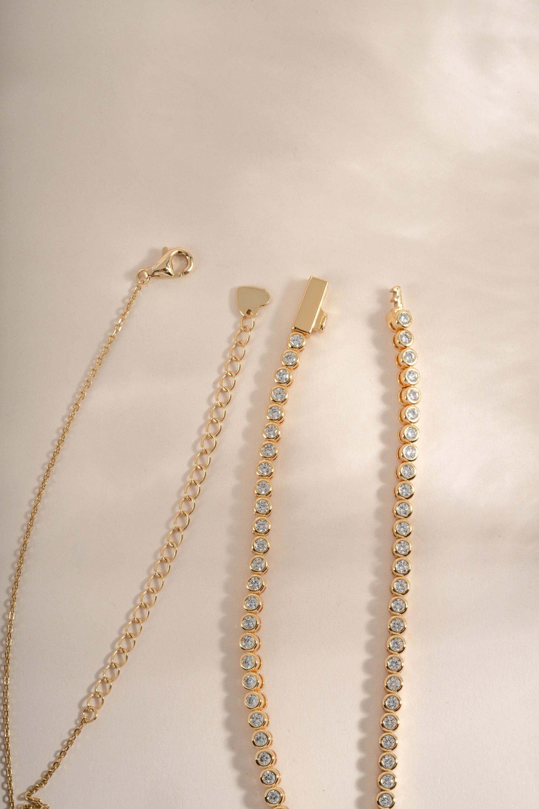 Close-up of Sami Jewels round bezel gold necklace bundle showcasing elegant, minimalist jewelry with smooth, polished finishes.