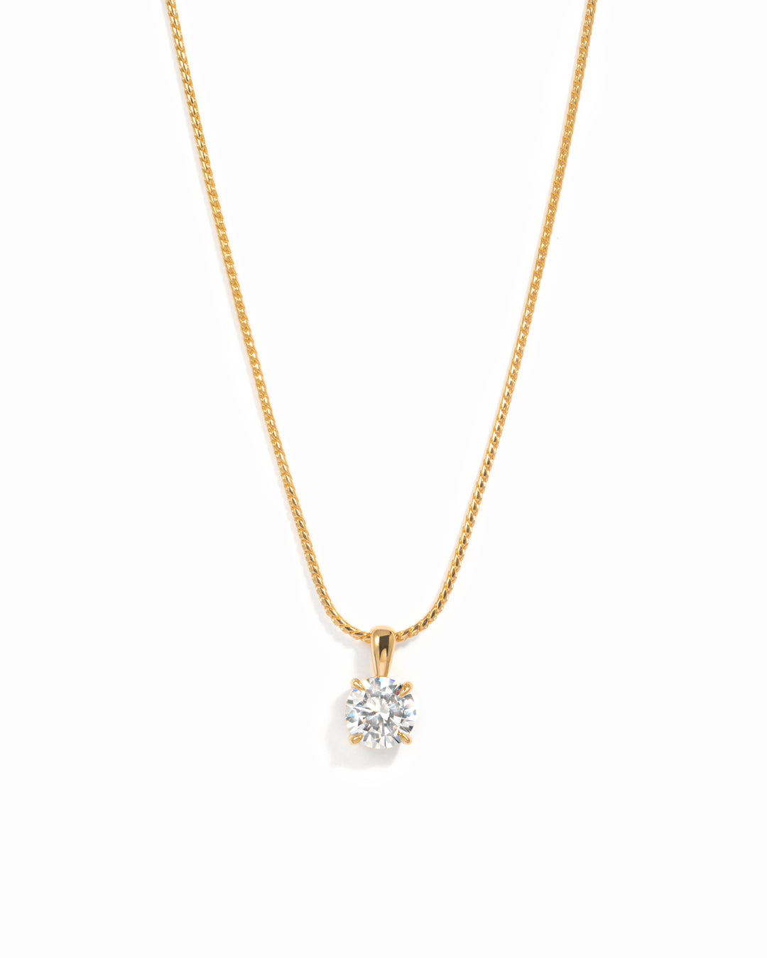 Gold round solitaire CZ pendant necklace on a white background.