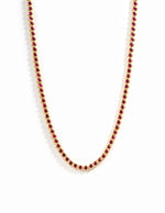 Gold Ruby Bezel Tennis Necklace by Sami Jewels featuring a row of vibrant rubies set in a sleek gold bezel design.
