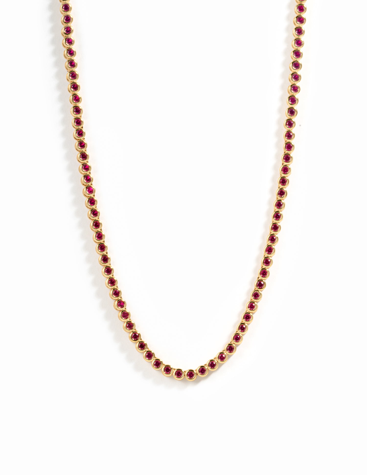 Gold Ruby Bezel Tennis Necklace by Sami Jewels featuring a row of vibrant rubies set in a sleek gold bezel design.
