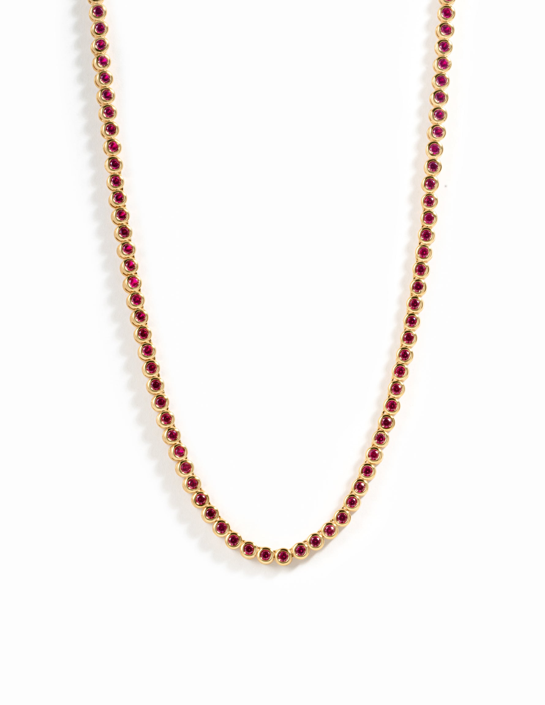 Gold Ruby Bezel Tennis Necklace by Sami Jewels featuring a row of vibrant rubies set in a sleek gold bezel design.