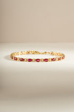 Gold Ruby Tennis Bracelet by Sami Jewels featuring dainty ruby stones and sparkling diamonds on a delicate bracelet.
