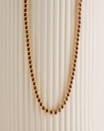 Gold Ruby Bezel Tennis Necklace by Sami Jewels featuring a row of vibrant rubies and sparkling diamonds on a sleek gold chain.