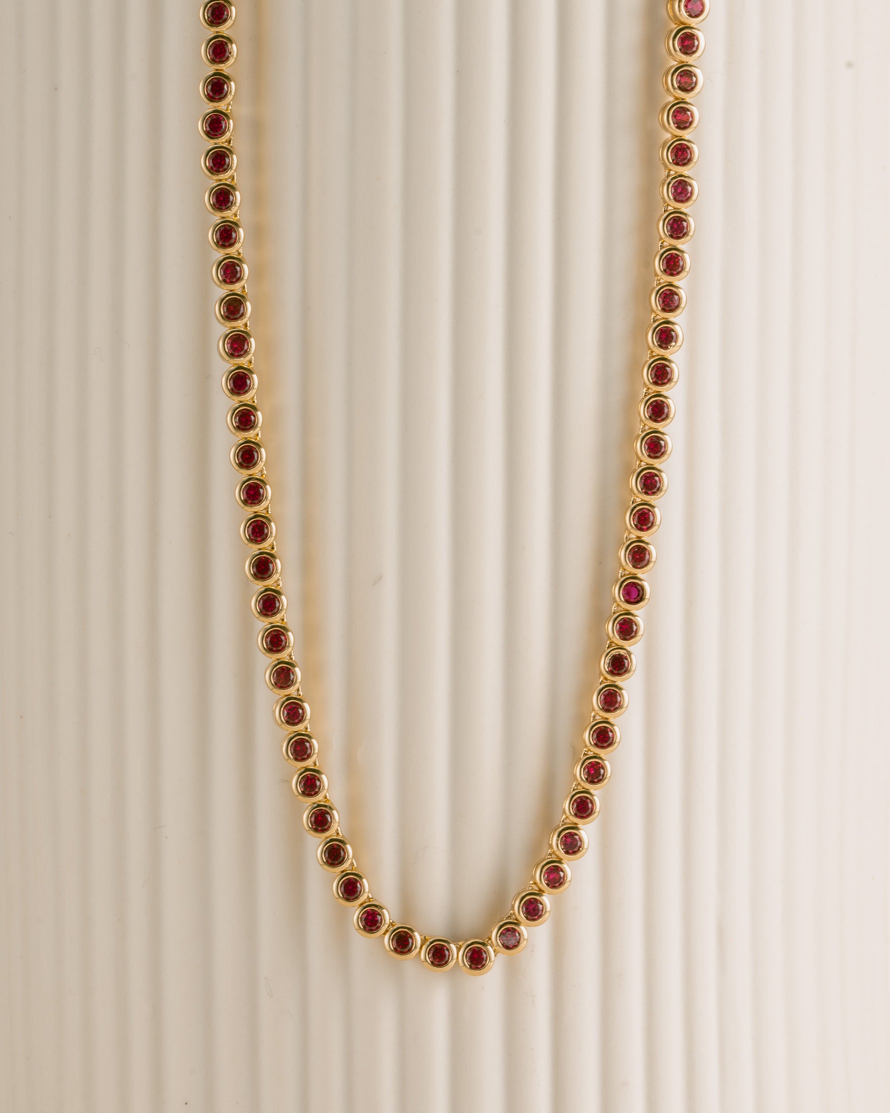 Gold Ruby Bezel Tennis Necklace by Sami Jewels featuring a row of vibrant rubies and sparkling diamonds on a sleek gold chain.
