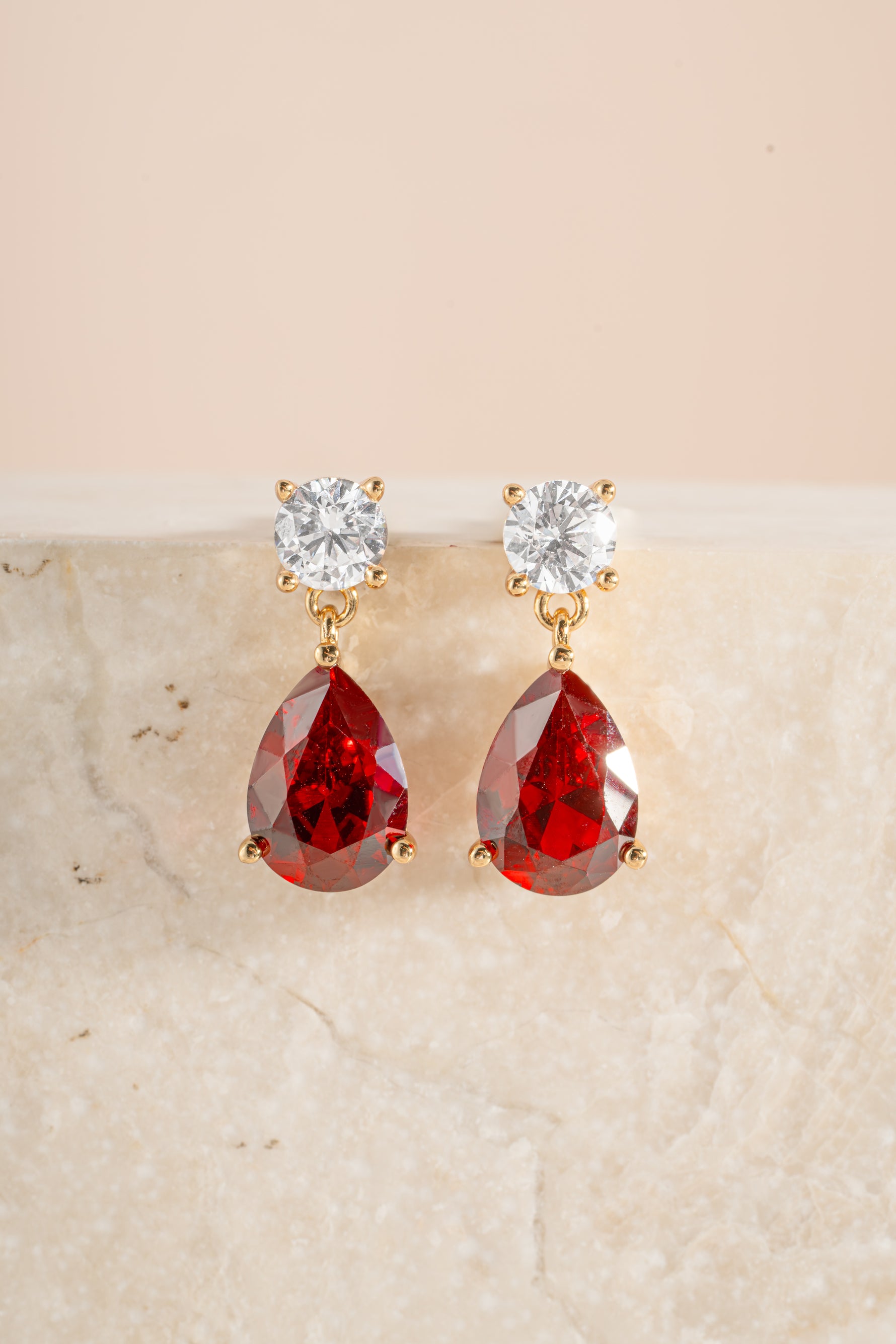 Gold ruby pear drop earrings by Sami Jewels featuring diamond stud details and elegant drop design.