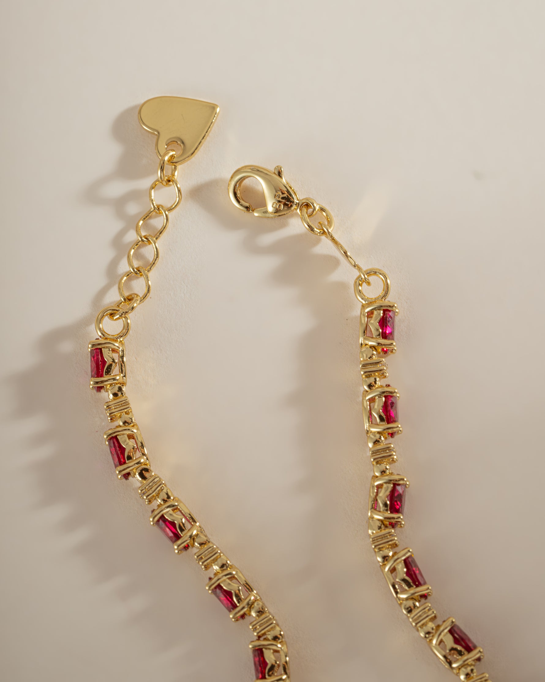 Gold Ruby Tennis Bracelet by Sami Jewels featuring a box clasp, showcasing vibrant rubies and elegant design.