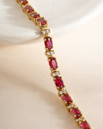 Gold Ruby Tennis Bracelet by Sami Jewels featuring sparkling ruby stones set in a sleek tennis bracelet design.