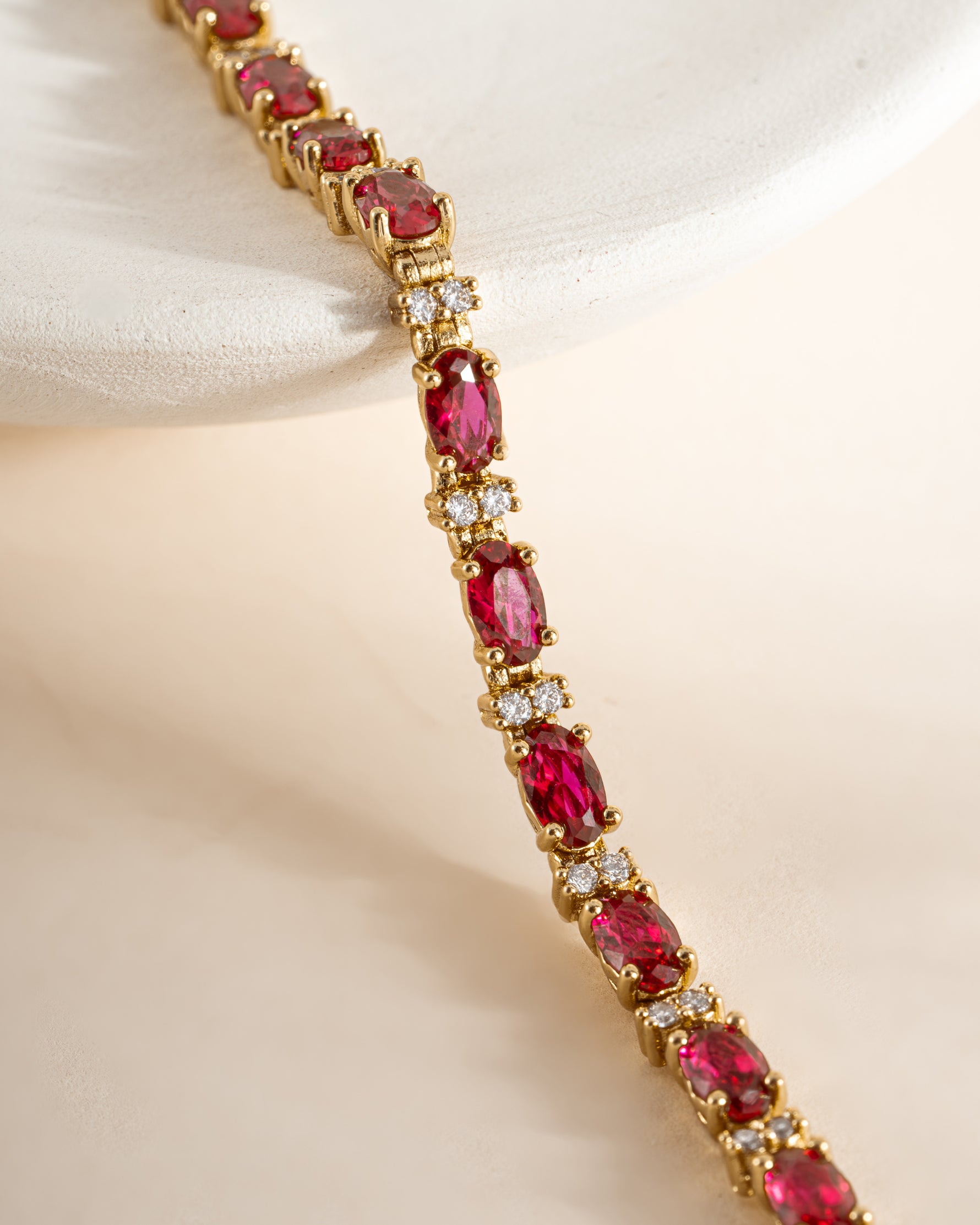 Gold Ruby Tennis Bracelet by Sami Jewels featuring sparkling ruby stones set in a sleek tennis bracelet design.