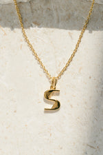gold "S" initial necklace neutral background