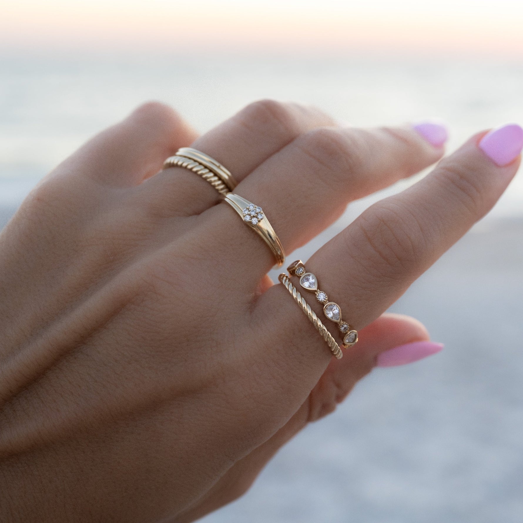 Model wearing gold stacking rings