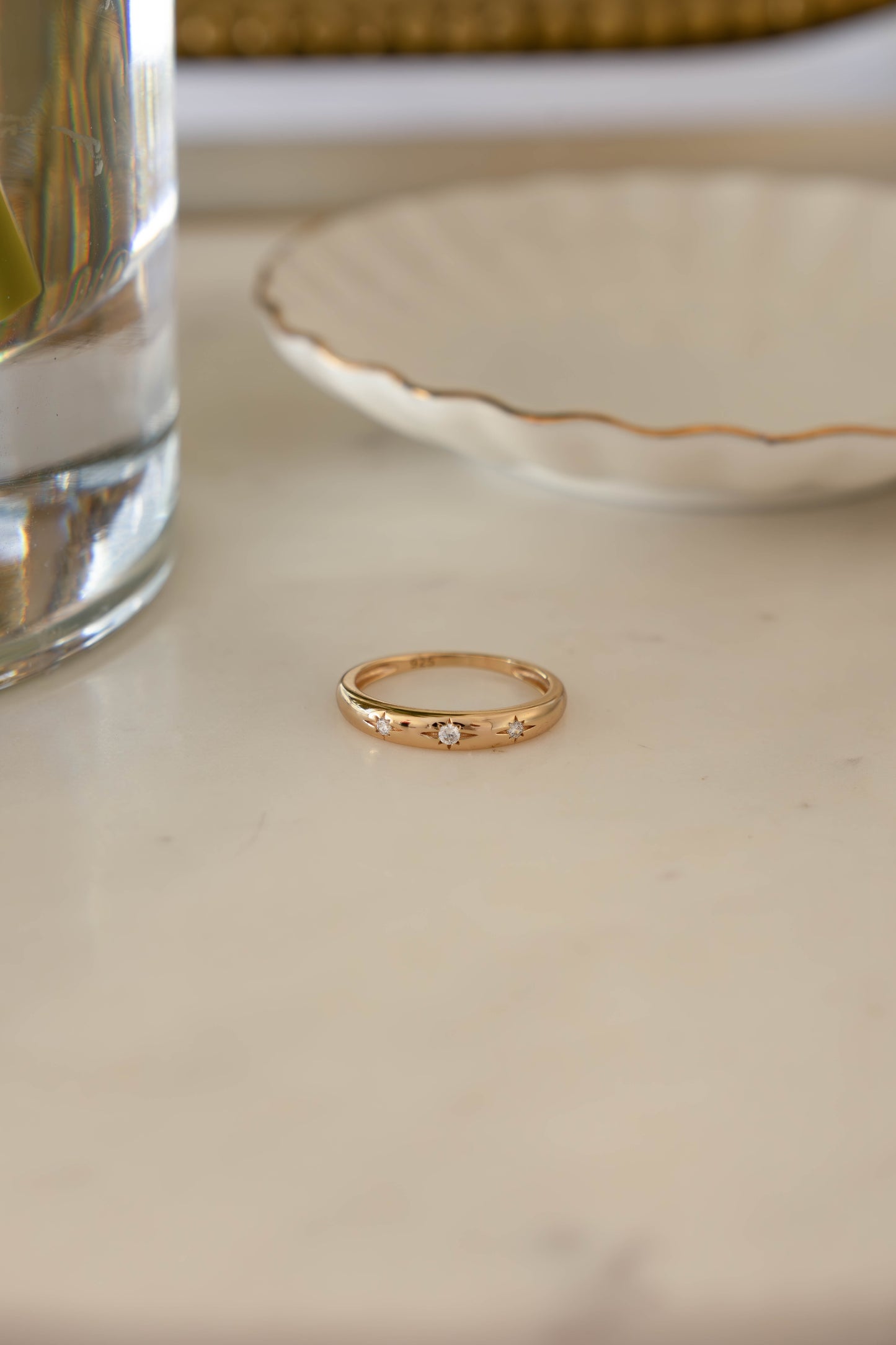 14k Gold Diamond Starburst Ring on marble background