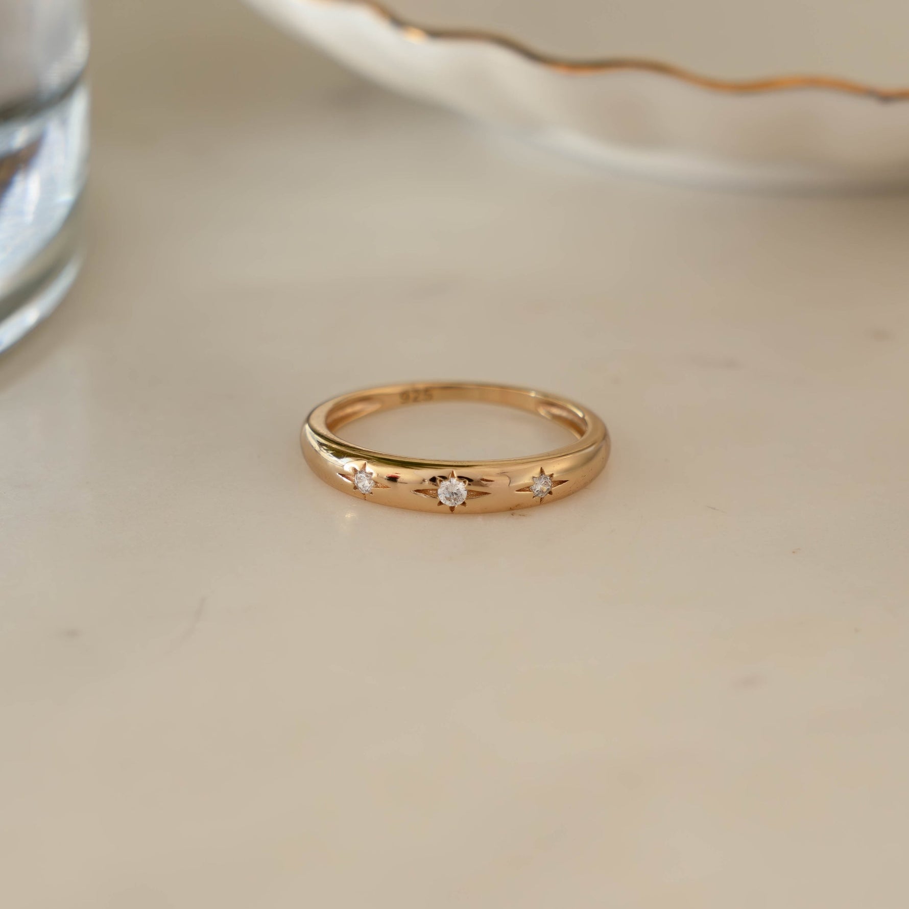 14k Gold Diamond Starburst Ring on marble background