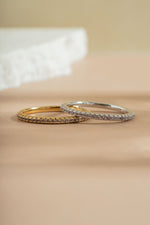 gold and sterling silver alexandrite eternity ring on neutral background