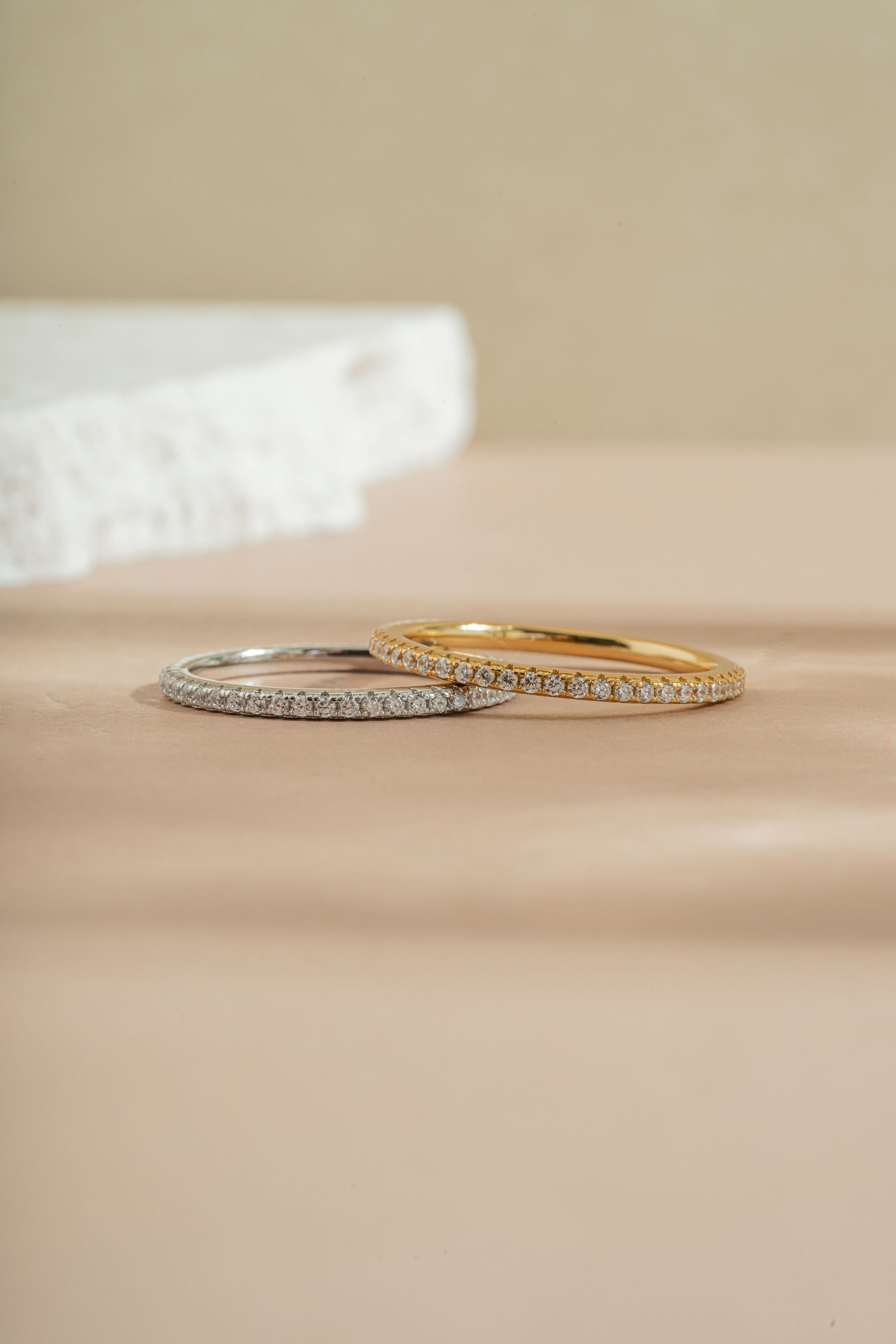 gold and sterling silver diamond eternity ring neutral background