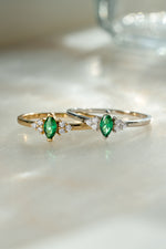 gold and sterling silver diamond emerald marquise ring on neutral background