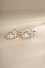 Sterling silver and gold marquise ring with baguette band by Sami Jewels, showcasing elegant geometric design and sparkling gemstones.