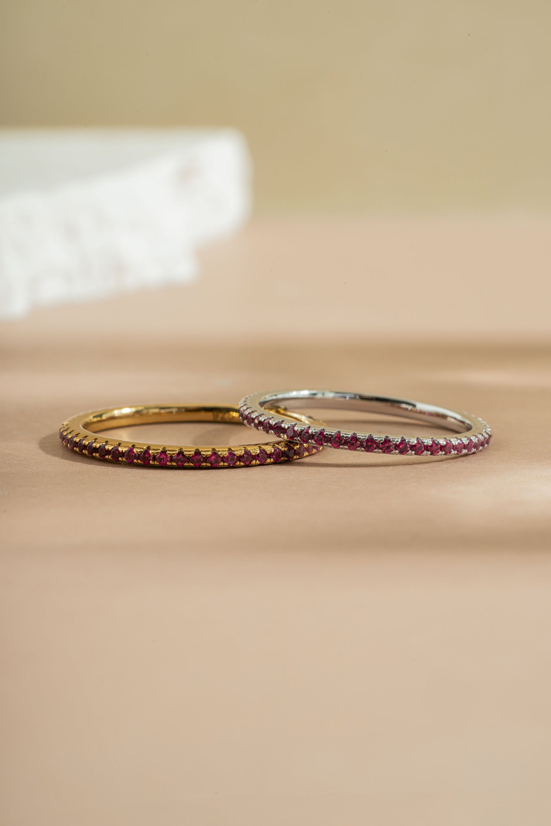 gold and sterling silver ruby birthstone eternity ring neutral background