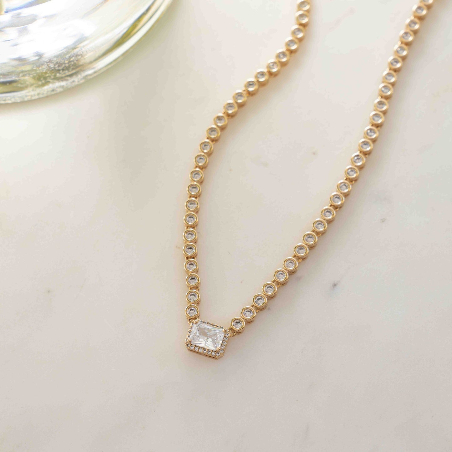 Chic gold diamond round tennis necklace for women on white background