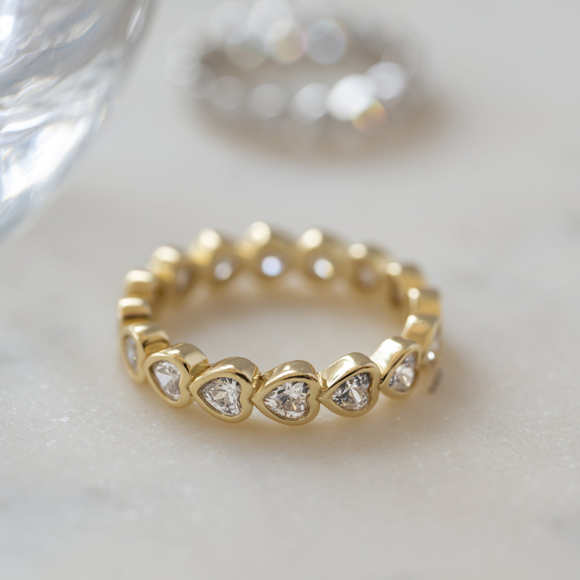 gold promise ring with heart shaped diamond stones