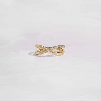 close up of gold wedding band with an X design