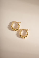 Gold graduated beaded hoop earrings from Sami Jewels, side profile showing layered beaded design and hoop shape.