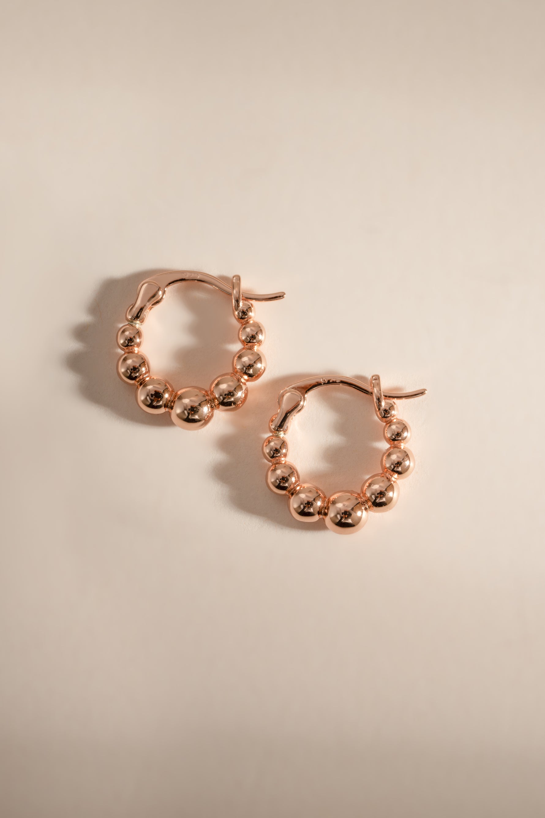 Rose gold Graduated Beaded Hoop Earrings by Sami Jewels, featuring a stylish layered beaded design on classic hoop earrings.