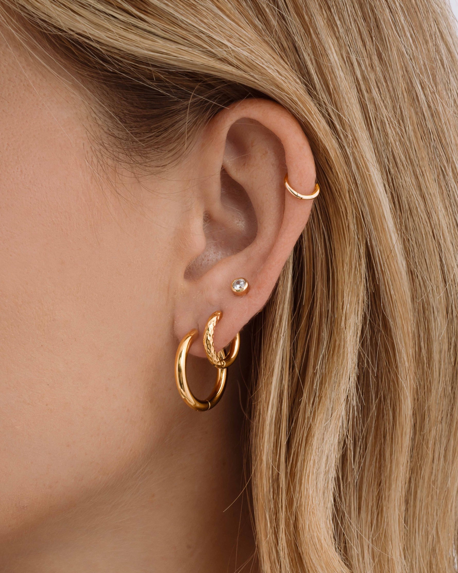 Gold stainless steel SS half-textured hoop earrings by Sami Jewels, showcasing a stylish and waterproof jewelry accessory.