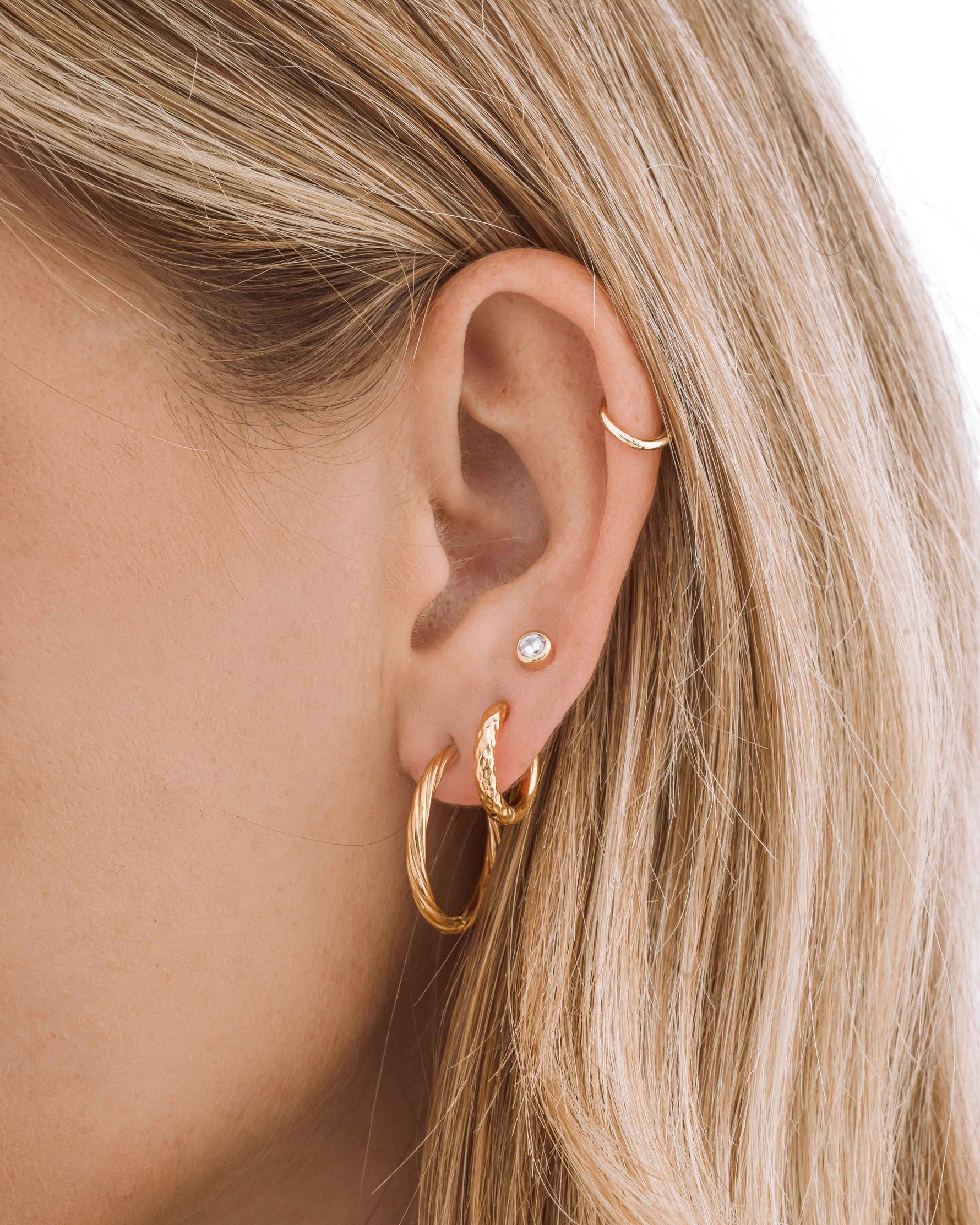 Gold stainless steel SS Half Textured Hoops earrings by Sami Jewels, featuring a close-up of the half-textured design on huggie-style earrings.
