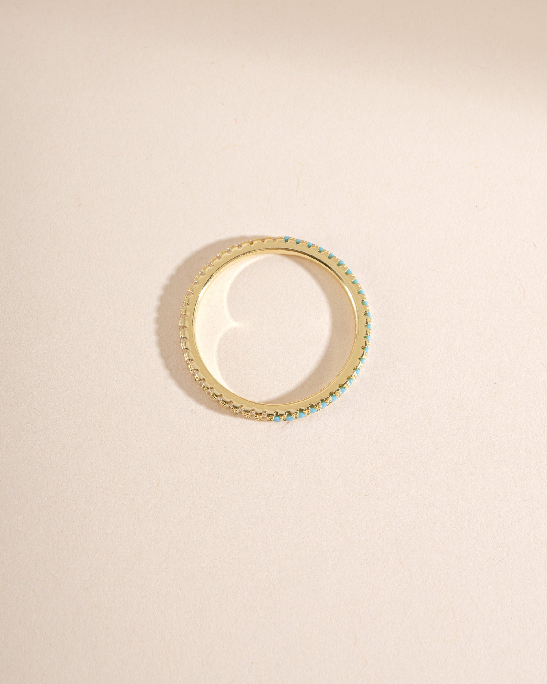 Gold Sami Jewels turquoise and diamond eternity ring, top view showing alternating turquoise stones and sparkling diamonds.