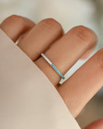 Sterling silver eternity ring with turquoise and diamond accents, showcasing a continuous band design by Sami Jewels.