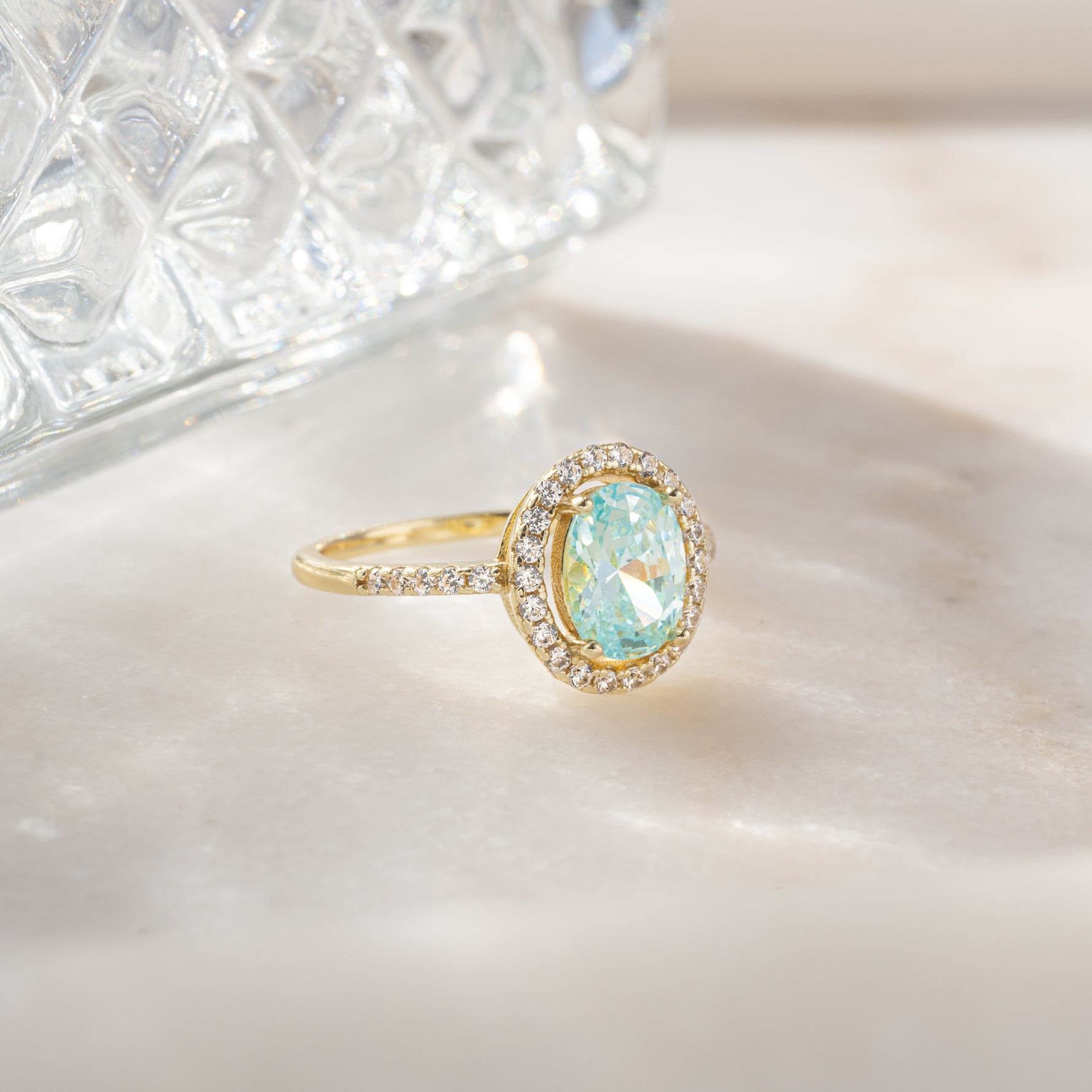 Sami Jewels Jules Statement Ring featuring a halo aquamarine gemstone set in gold with intricate band details.