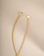 Gold Halo Emerald Cut Necklace on Cuban Chain with lobster clasp by Sami Jewels, showcasing a sparkling emerald-cut pendant.