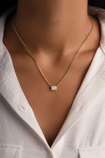 Gold Halo Emerald Cut Necklace on Cuban Chain, styled on a model showcasing elegant jewelry design by Sami Jewels.