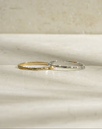 Hammered gold and sterling silver stacking ring by Sami Jewels with textured, shiny surface and layered design.