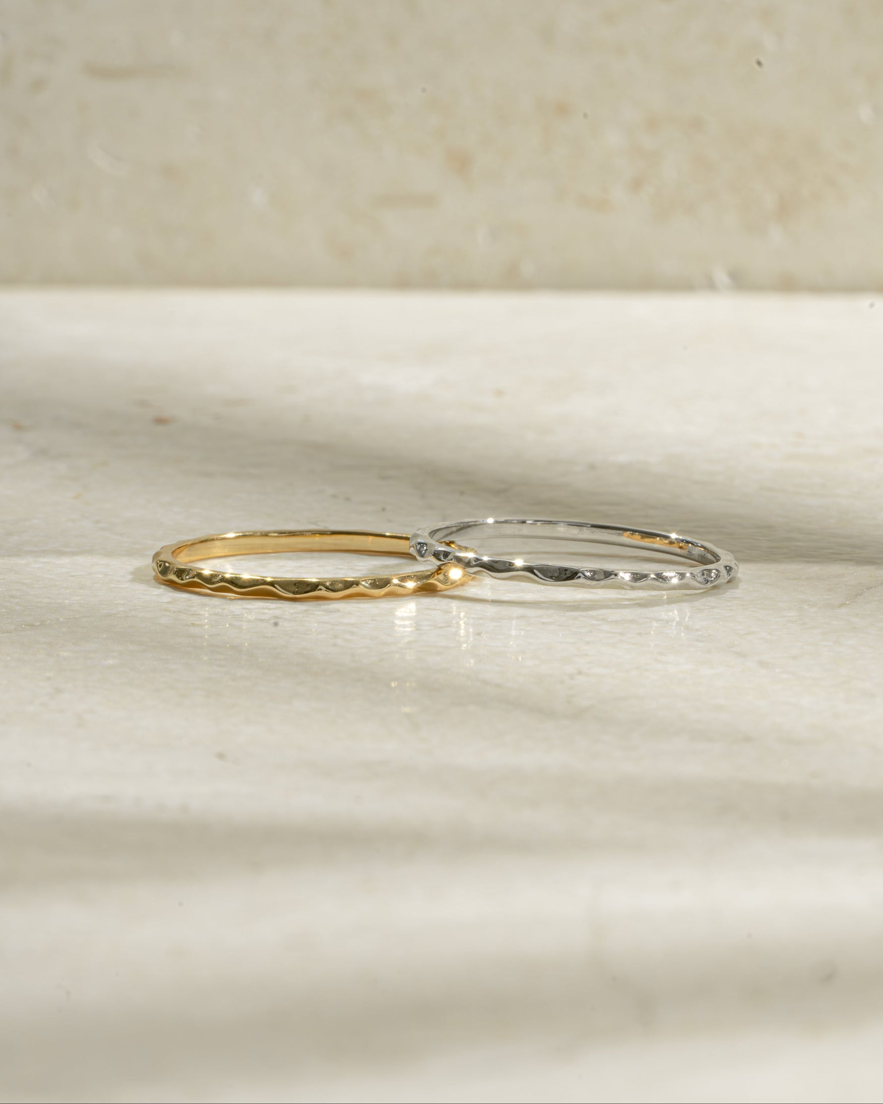 Hammered gold and sterling silver stacking ring by Sami Jewels with textured, shiny surface and layered design.