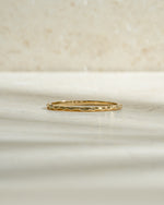 Gold hammered stacking ring from Sami Jewels, featuring a textured surface and modern design, shown from the front view.