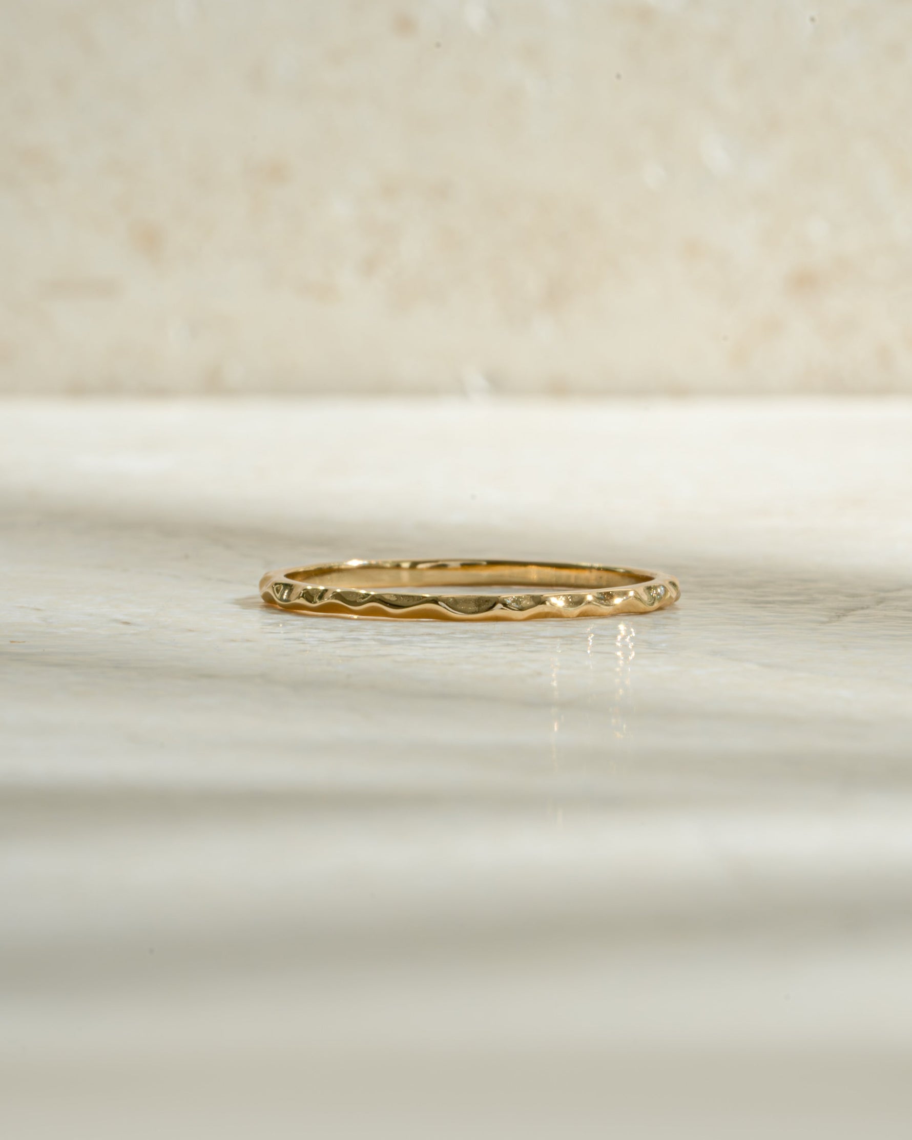 Gold hammered stacking ring from Sami Jewels, featuring a textured surface and modern design, shown from the front view.