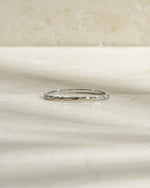 Sterling silver hammered stacking ring from Sami Jewels with a textured, shiny surface, designed for versatile layered jewelry.