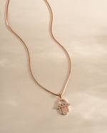 Rose gold Hamsa necklace from Sami Jewels featuring intricate design and a protective charm, front view of the jewelry piece.