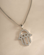 Close-up of Sami Jewels sterling silver Hamsa necklace showing intricate hand pendant design.