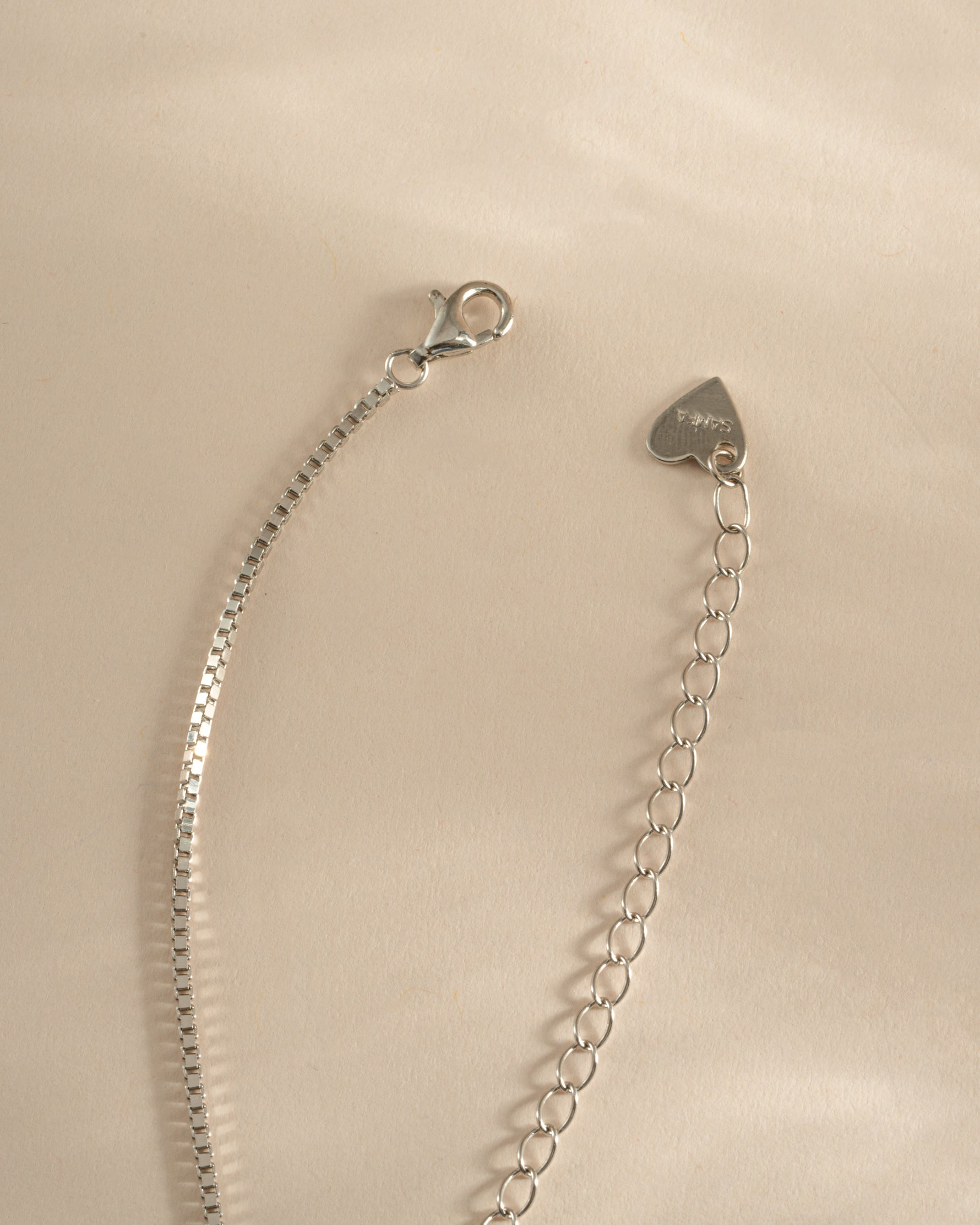 Sterling silver Hamsa necklace with lobster clasp closure by Sami Jewels, featuring intricate Hamsa hand charm on a delicate chain.