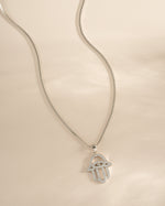 Sterling silver Hamsa necklace from Sami Jewels featuring a detailed protective hand pendant.