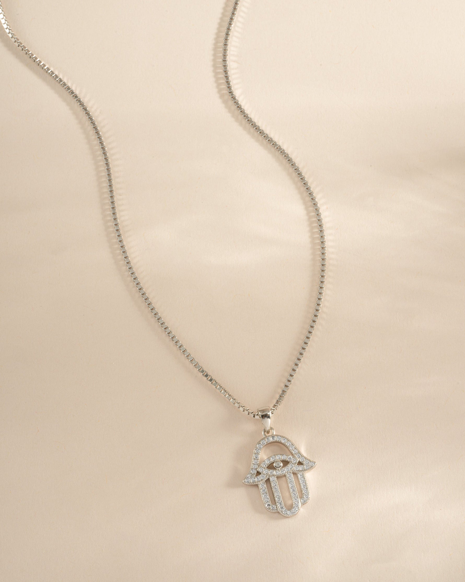 Sterling silver Hamsa necklace from Sami Jewels featuring a detailed protective hand pendant.